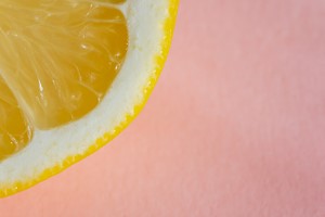 Quarter of lemon on pink background picture