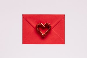 Colorful gift envelope with heart on pink background picture